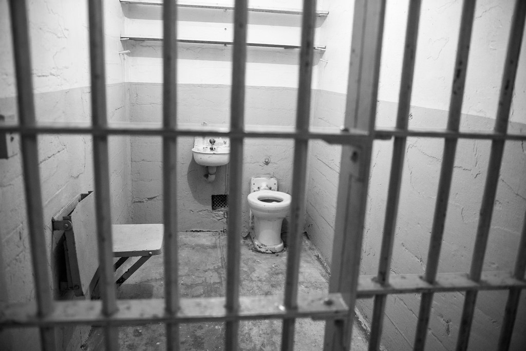 jail cell with toilet black and white