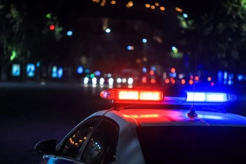 An Orange County police vehicle with lights flashing.
