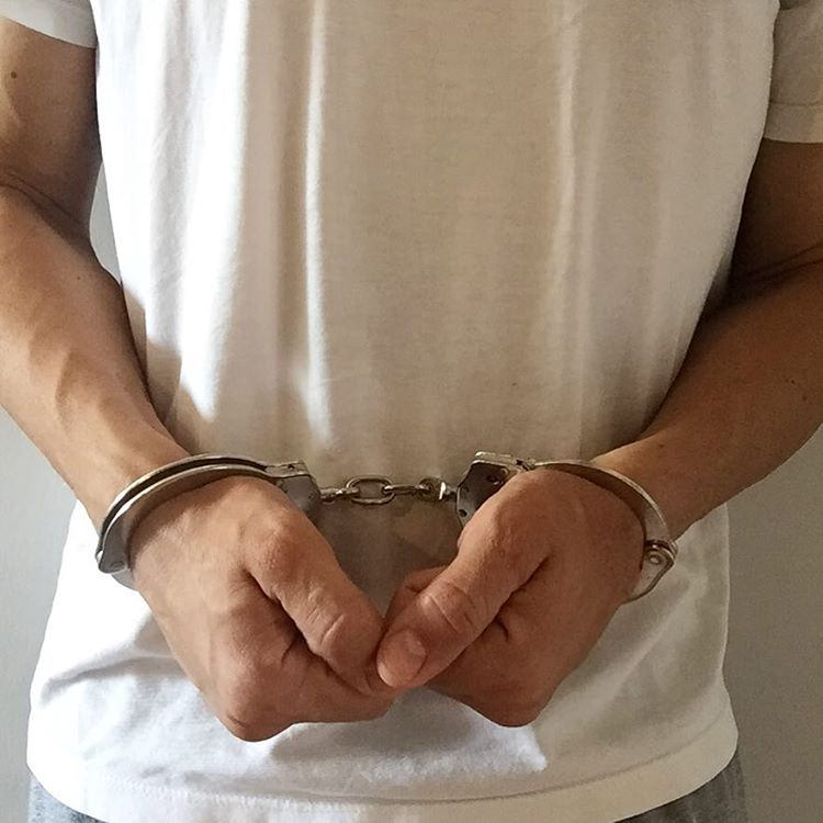 man under arrest in handcuffs