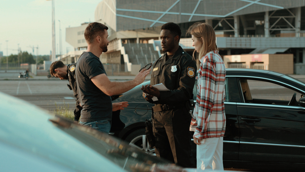 police officer completes an accident report at the scene of a car accident