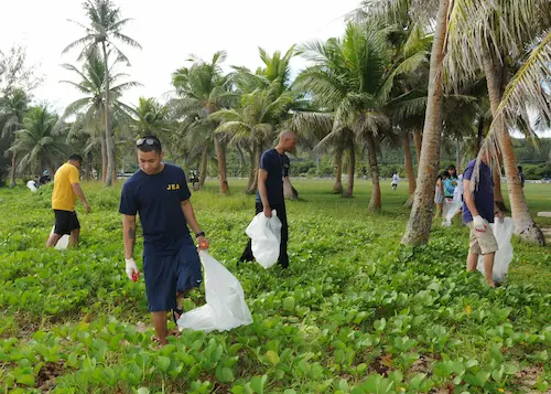 US Navy Sailors pick up trash at a community event